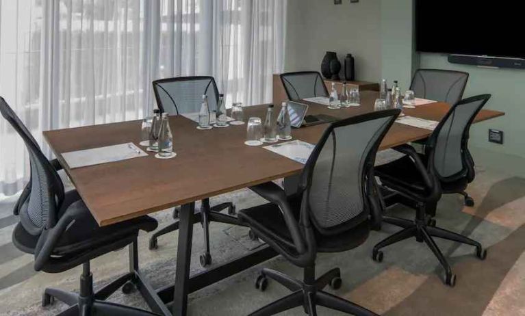 Meeting room with small table and TV screen at the Hilton Garden Inn Umhlanga Arch.