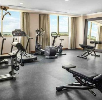 Bright fitness center with windows at the Hilton Garden Inn Al Jubail.