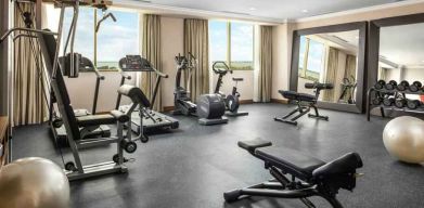 Bright fitness center with windows at the Hilton Garden Inn Al Jubail.