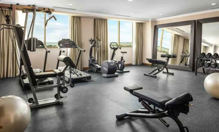 Bright fitness center with windows at the Hilton Garden Inn Al Jubail.