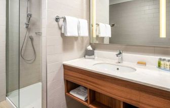 clean and spacious bathroom with shower at Hilton Garden Inn Bucharest Old Town.