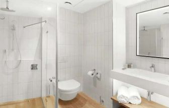 clean and spacious bathroom with shower at Hilton Garden Inn Bucharest Airport.