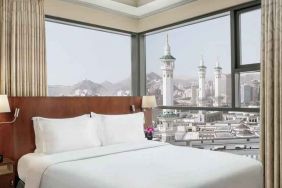 Hotel room with large windows and view at the Hilton Suites Makkah.