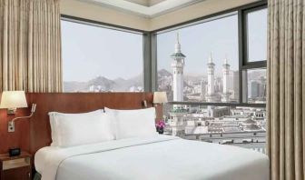 Hotel room with large windows and view at the Hilton Suites Makkah.