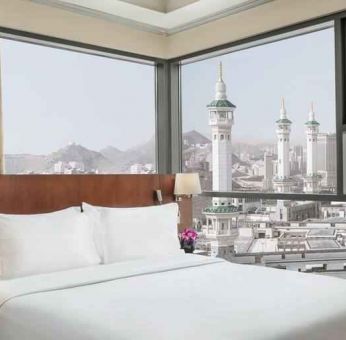 Hotel room with large windows and view at the Hilton Suites Makkah.