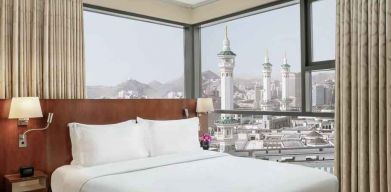 Hotel room with large windows and view at the Hilton Suites Makkah.