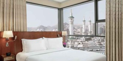 Hotel room with large windows and view at the Hilton Suites Makkah.