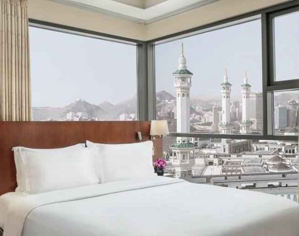 Hotel room with large windows and view at the Hilton Suites Makkah.