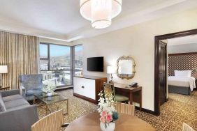 Living room with working station at the Hilton Suites Makkah.