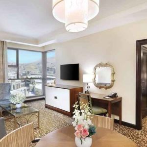 Living room with working station at the Hilton Suites Makkah.