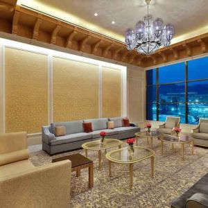 Seating area with large window and view at the Hilton Makkah Convention Hotel.