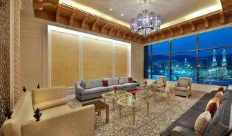 Seating area with large window and view at the Hilton Makkah Convention Hotel.