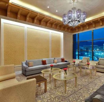 Seating area with large window and view at the Hilton Makkah Convention Hotel.