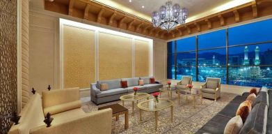 Seating area with large window and view at the Hilton Makkah Convention Hotel.