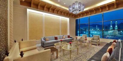 Seating area with large window and view at the Hilton Makkah Convention Hotel.