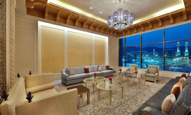 Seating area with large window and view at the Hilton Makkah Convention Hotel.