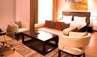 luxurious king suite with lounge area, business desk, and chair at DoubleTree by Hilton Nairobi Hurlingham.