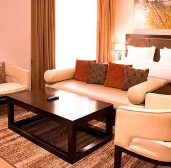 luxurious king suite with lounge area, business desk, and chair at DoubleTree by Hilton Nairobi Hurlingham.