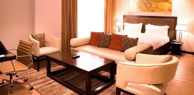 luxurious king suite with lounge area, business desk, and chair at DoubleTree by Hilton Nairobi Hurlingham.