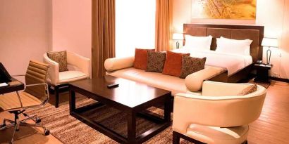 luxurious king suite with lounge area, business desk, and chair at DoubleTree by Hilton Nairobi Hurlingham.