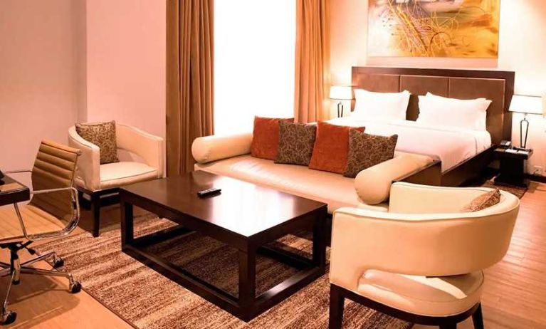 luxurious king suite with lounge area, business desk, and chair at DoubleTree by Hilton Nairobi Hurlingham.