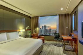 King bedroom with desk along the window at the Hilton Sukhumvit Bangkok.