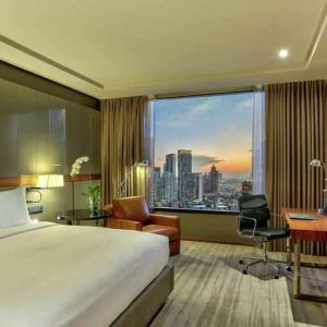 King bedroom with desk along the window at the Hilton Sukhumvit Bangkok.