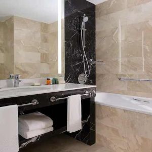 clean and spacious king bathroom with bath and shower at Hilton Astana.