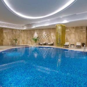 stunning indoor pool with sunbeds at Hilton Astana.