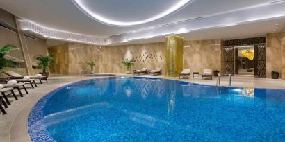 stunning indoor pool with sunbeds at Hilton Astana.