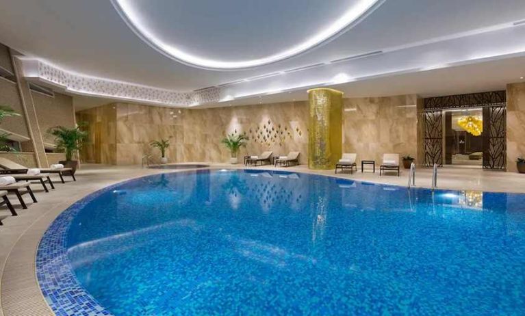 stunning indoor pool with sunbeds at Hilton Astana.