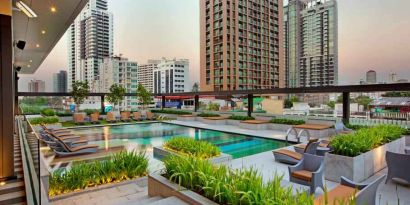 Outdoor pool area suitable as workspace at the DoubleTree by Hilton Sukhumvit Bangkok.