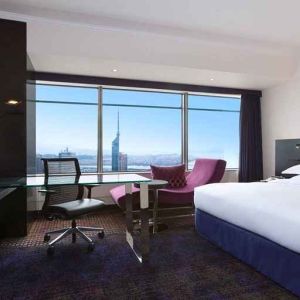 spacious king room with TV, work desk, chair, and couch at Hilton Fukuoka Sea Hawk.