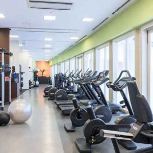 well equipped fitness center with treadmills, bicycles, and weights at Hilton Fukuoka Sea Hawk.