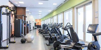 well equipped fitness center with treadmills, bicycles, and weights at Hilton Fukuoka Sea Hawk.