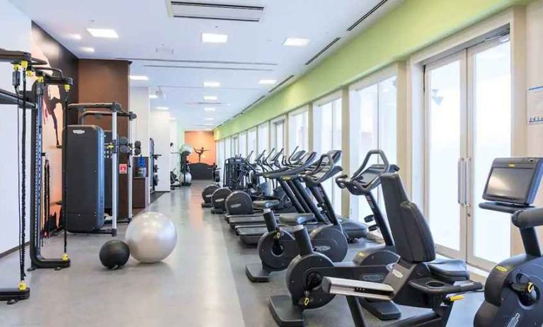 well equipped fitness center with treadmills, bicycles, and weights at Hilton Fukuoka Sea Hawk.