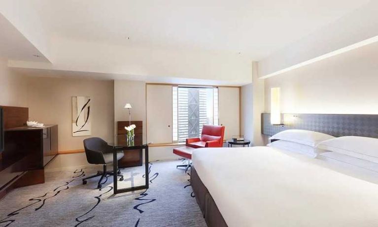 spacious king suite with TV, business desk, and couch at Hilton Tokyo.