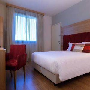 delux king room with TV, desk, and chair at Hilton Garden Inn Milan Malpensa.