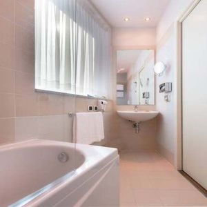 clean and spcious bathroom with bath and shower at Hilton Garden Inn Milan Malpensa.