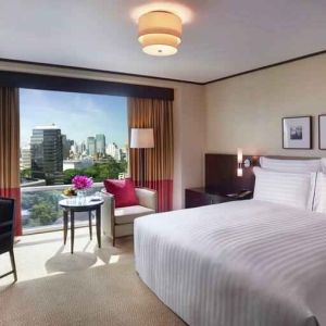 King bedroom with desk at the Conrad Bangkok.