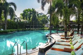 Beautiful outdoor pool with lounges at the Conrad Bangkok.