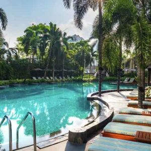 Beautiful outdoor pool with lounges at the Conrad Bangkok.