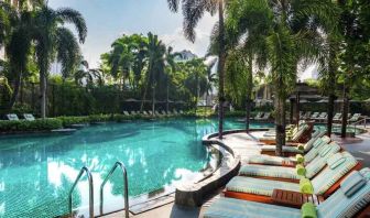 Beautiful outdoor pool with lounges at the Conrad Bangkok.