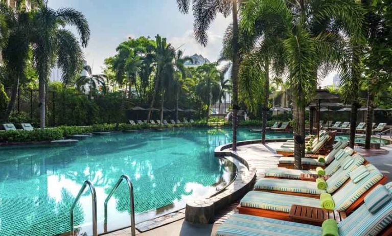 Beautiful outdoor pool with lounges at the Conrad Bangkok.