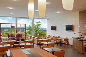 Seating area with TV screens at the Hilton Zurich Airport.