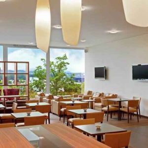 Seating area with TV screens at the Hilton Zurich Airport.