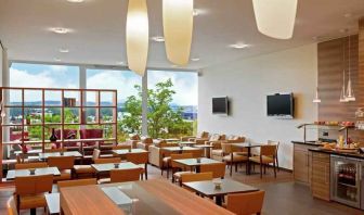 Seating area with TV screens at the Hilton Zurich Airport.