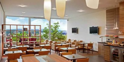 Seating area with TV screens at the Hilton Zurich Airport.