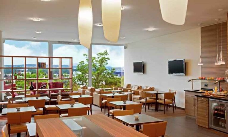 Seating area with TV screens at the Hilton Zurich Airport.