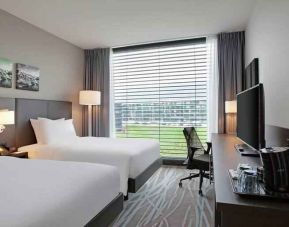 Twin room with desk and TV screen at the Hilton Garden Inn Zurich Limmattal.